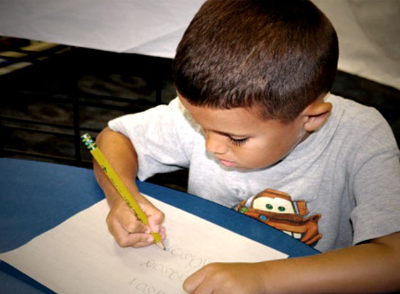 young boy writing